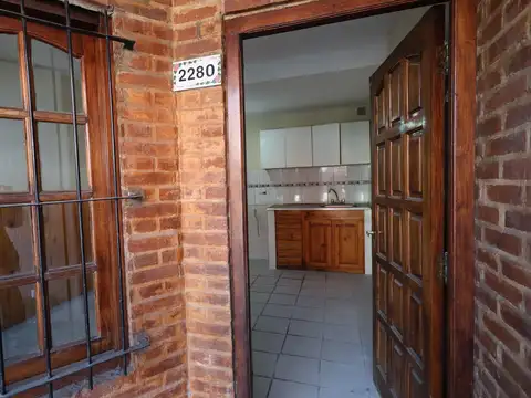 Departamento tipo 2 ambientes con patio, y entrada para vehículo pequeño.